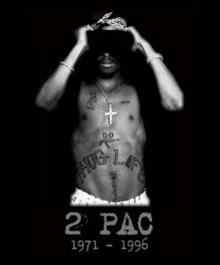 Tupac Shakur with Thug Life tattooed on his abdomen