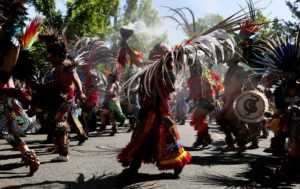 Traditional Aztec dancers headed up the annual El Comite May Day March for Worker and Immigrant Rights, stopping to perform numerous times, Sunday May 1, 2016, in Seattle. (Ken Lambert / The Seattle Times)