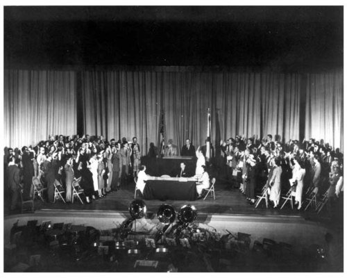 14 April 55 In an unprecedented ceremony held at Huntsville High School, 103 German-born scientists, technicians, and members of their families became American citizens. Among those taking the oath of citizenship was Dr. Wernher von Braun. 